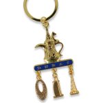 Gold-toned keychain featuring an Arabic Dallah coffee pot and hanging charms of the Burj Khalifa, Burj Al Arab, and Museum of the Future