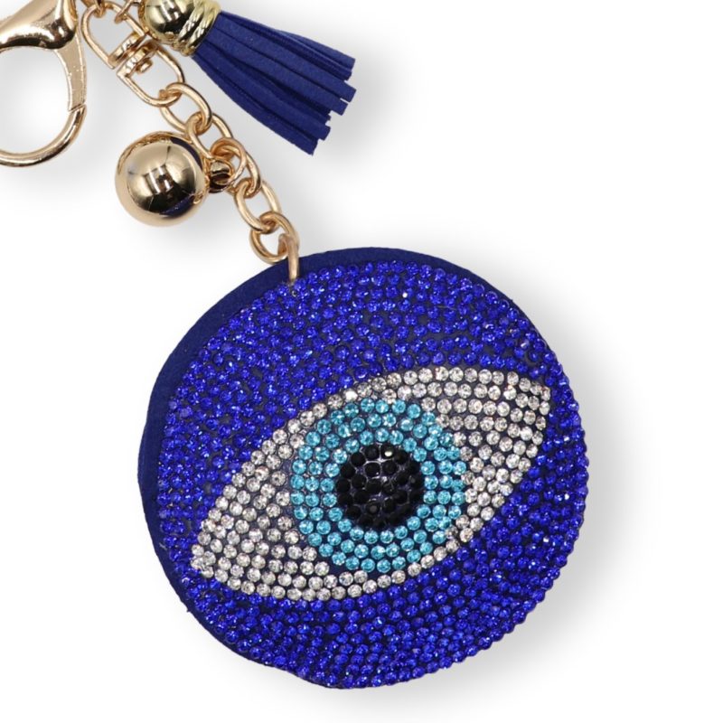 Round blue crystal-encrusted Evil Eye keychain with gold-tone hardware and a blue fabric tassel..