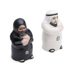 Ceramic salt and pepper shakers shaped like a traditional Arab couple; the male shaker is in a white Kandura and the female shaker is in a black Abaya.