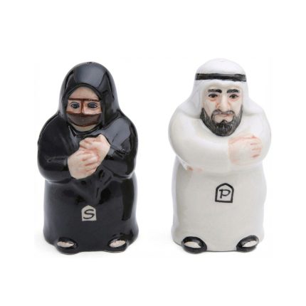 Ceramic salt and pepper shakers shaped like a traditional Arab couple; the male shaker is in a white Kandura and the female shaker is in a black Abaya.