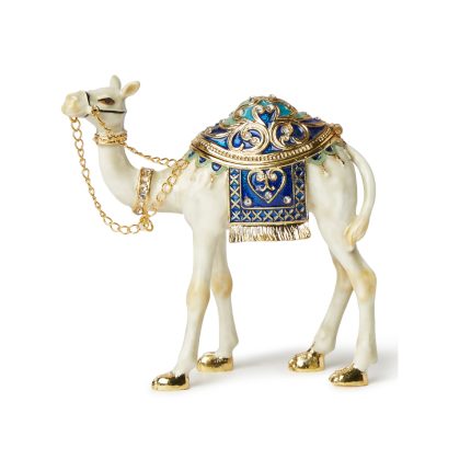White and gold enameled camel figurine with blue crystal saddle and gold-tone chain bridle, featuring a magnetic opening for jewelry storage.