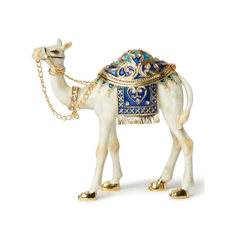 White and gold enameled camel figurine with blue crystal saddle and gold-tone chain bridle, featuring a magnetic opening for jewelry storage.